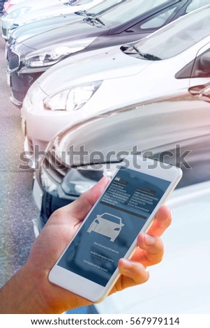 hand holding smartphone against view of row new car