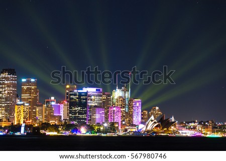Sydney cityscape at night with colorful lights illuminating modern city skyline