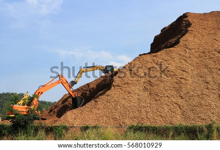 Woodchip Mountain with Backhoes working