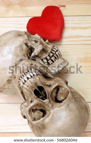 human skull with red heart on wooden background, top view. Still life Image and select focus