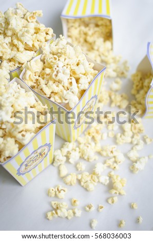 Popcorn homemade yellow red and white cardboard box on white background