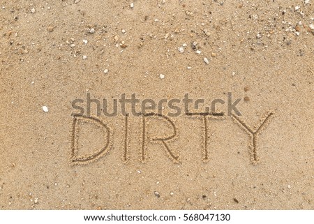 Handwriting words "DIRTY" on sand of beach