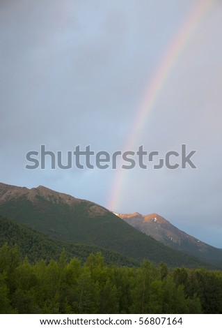 Rainbow over the Chugach range in early morning Alaska.