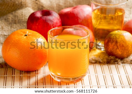 Fresh orange and apple juice in a glass