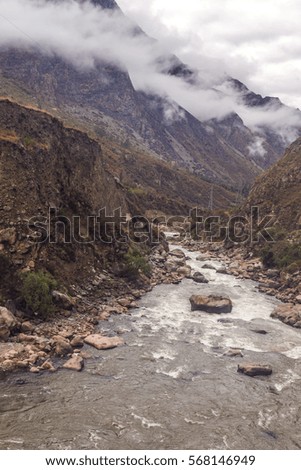 Vertical peruvian landscape, with mountains, clouds and river. Cloudy weather.