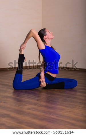 Woman practicing yoga in the fitness studio