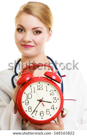 Health care medical checkup concept. Doctor with big red alarm clock reminding to do health check isolated on white