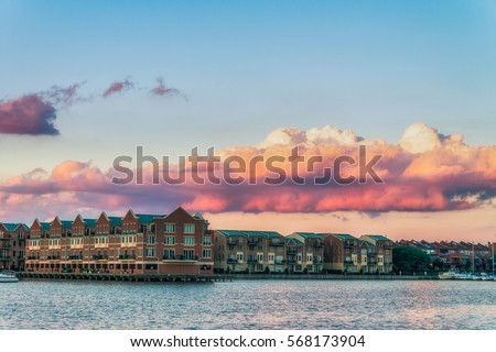 Baltimore, USA. Harbor view at sunset and deep colored sky. Splittoned, vivid image 