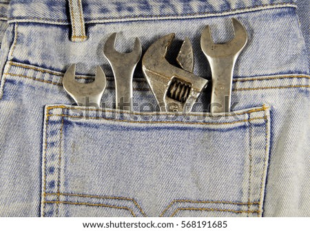 Wrench tools in the blue pocket jeans