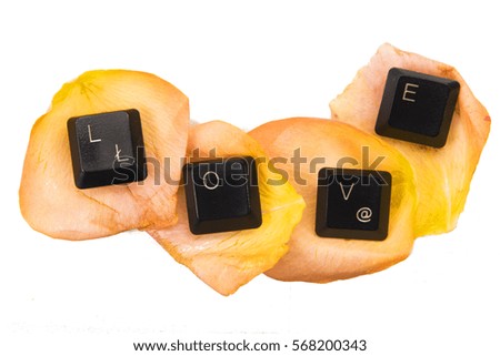 Valentine's Day: Keyboard letter spelling LOVE on yellow rose petals