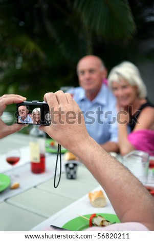 Person taking a picture of a couple of senior