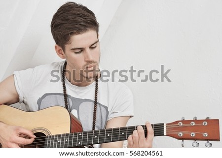 Young Caucasian man playing guitar