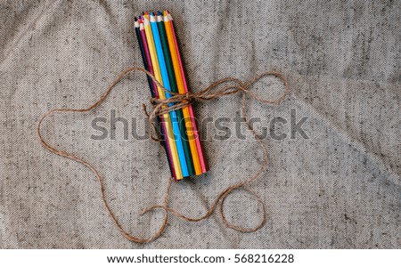 Colored pencils tied with thread