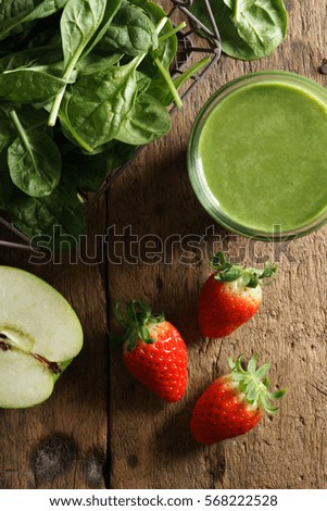 healthy green smoothie with spinach, green apple and fresh strawberry