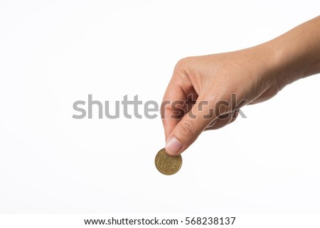 Woman hand holding coin to collecting. Royalty-Free Stock Photo #568238137