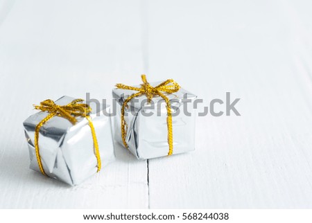 two romantic silver color valentines day gift boxes on white wooden table background