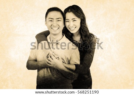 Portrait of cheerful couple against grey background