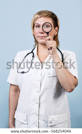 Female doctor looking through loupe