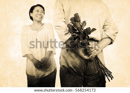 Man standing with roses by woman against grey background