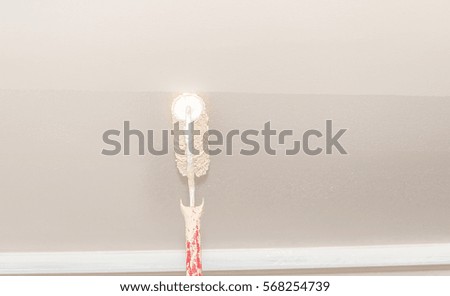 Painter use paint roller on white wall