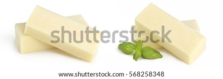 piece of cheese isolated on white background. Square cheese pieces with herbs on a white background.