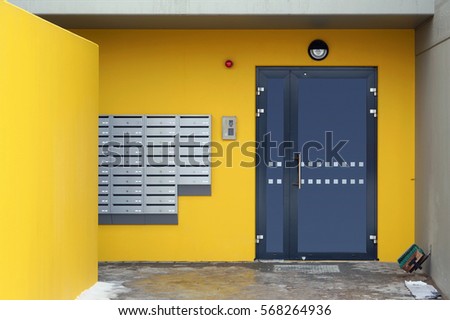 Mailboxes, the coded lock and security alarm system on yellow wall  near a door in a new house