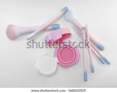 Pink cosmetic and pantone brushes