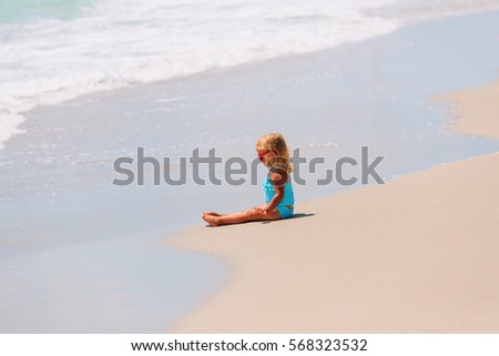 little girl play with water at beach