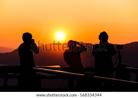 Silhouette of photographer, taking pictures of the beautiful moments during the sunset ,sunrise.