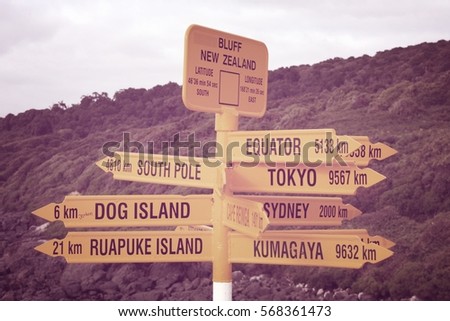 Destinations in New Zealand - city distance signs. Desaturated filtered color tone.