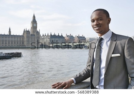 Portrait of a smiling African American businessman with buildings in background
