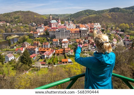 Young woman taking picture of Gothic castle Loket, Karlovy Vary region, Sokolov district, Bohemia, Czech Republic