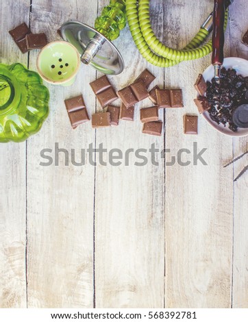 Hookah on a wooden background. Tobacco fruit. Selective focus.