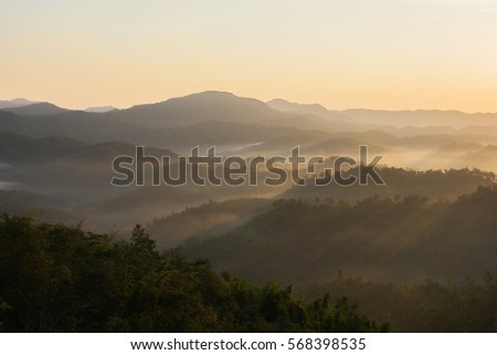 A picture of beautiful sky and foggy of layer mountain gold sunrise, Thailand.