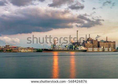Baltimore, USA. Harbor and street view at sunset and deep colored sky. Splittoned, vivid image 