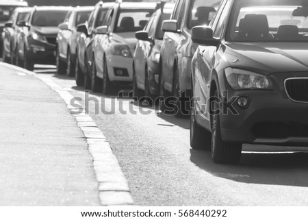 traffic jam on the country road in clear summer day , black-and-white image