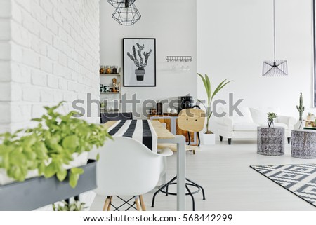 Well-lighted dining area of modern and sapcious loft