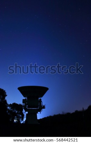 Silhouette of millimeter wave telescope under the night sky in Kinko-wan Park,Kagoshima Royalty-Free Stock Photo #568442521