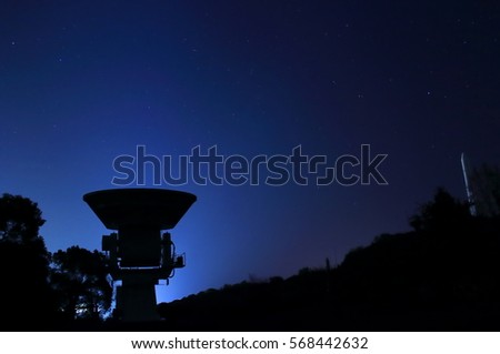 A millimeter wave telescope and a full scale model of japanese rocket  Royalty-Free Stock Photo #568442632