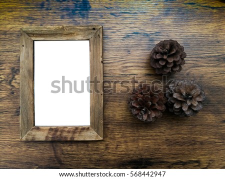 Brown wood picture frame on a wooden table.