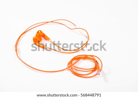 Orange earbud headphones isolated on white background