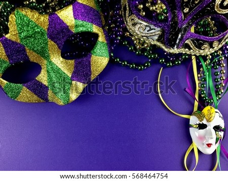 Mardi Gras decor on a purple background with copy space