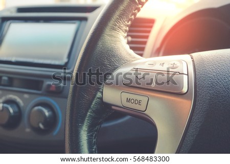 Control buttons on steering wheel in a car