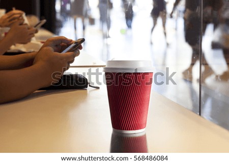 People sit in a cafe and talk on the iPhone.