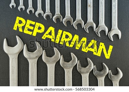 concept picture: wrench on a black background with the word (REPAIRMAN)