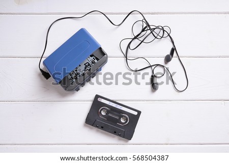 vintage walkman or cassette player with earbuds and mix tape Royalty-Free Stock Photo #568504387