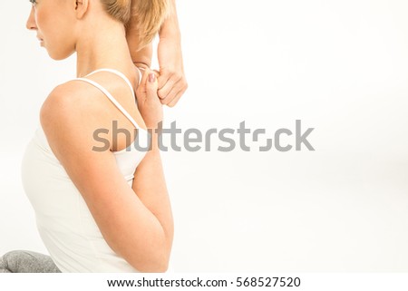 Side view of athletic woman stretching isolated on white