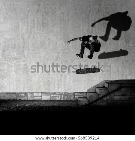 Skater making 360 flip trick from 4 stairs - artistic motion blur shot in black and white color tone.