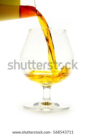 strong alcohol drink is poured from a bottle into a glass as a preparation for the holiday