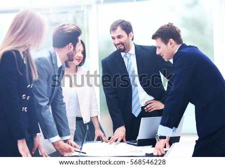 Business people working and discussing together at meeting in of